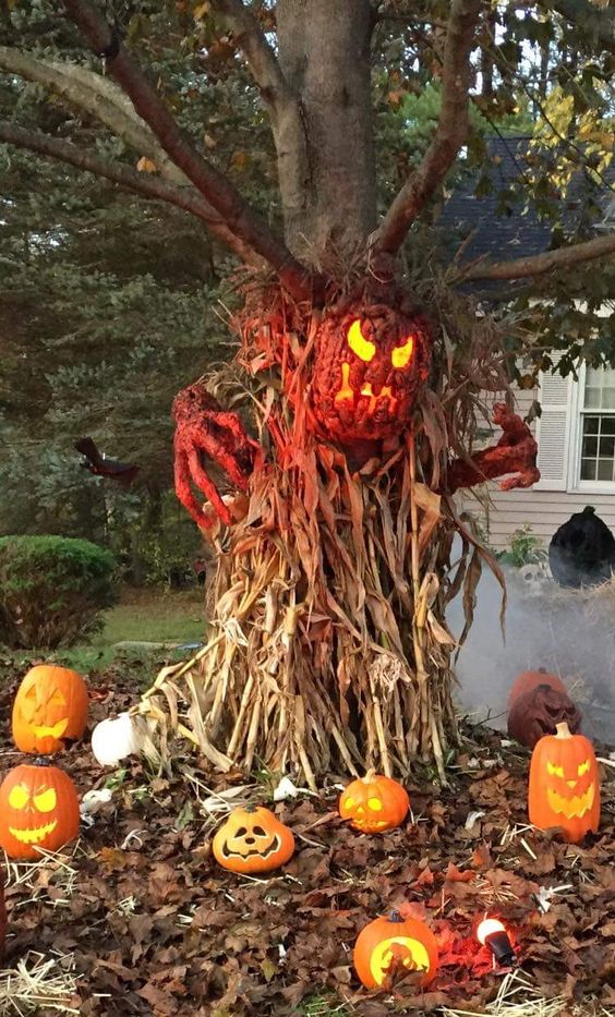 a scary outdoor decoration of corn husks pumpkin lanterns a bloody pumpkin and hands is fantastic